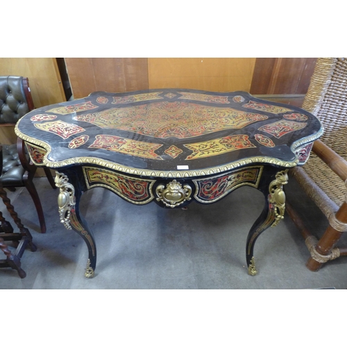 163 - A French style ebonised, brass and faux tortoiseshell bureau plat