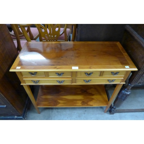 176 - A yew wood six drawer console table