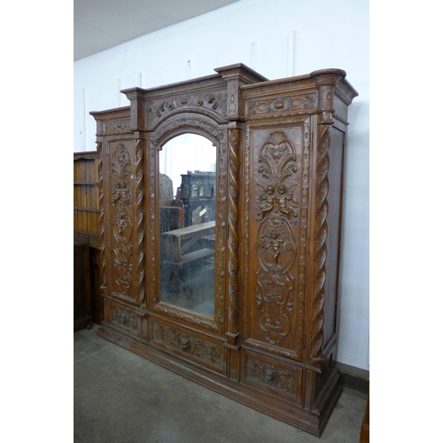 194 - An Anglo Indian heavily carved hardwood wardrobe