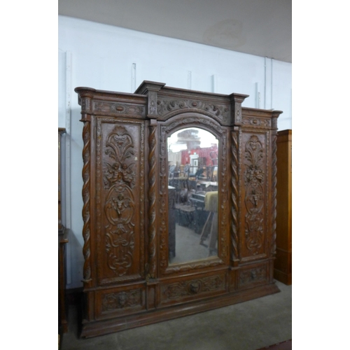 194 - An Anglo Indian heavily carved hardwood wardrobe