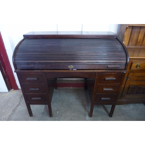 197 - An early 20th Century oak tambour roll top desk