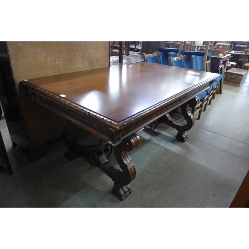 198 - A Spanish hardwood and wrought iron extending refectory dining table