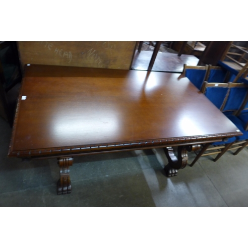 198 - A Spanish hardwood and wrought iron extending refectory dining table