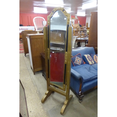 207 - An ebonised and gilt cheval mirror