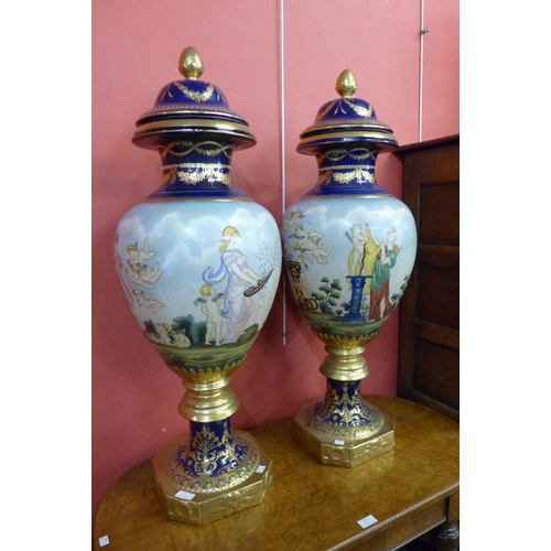 21 - A pair of large Vienna style porcelain vases and covers