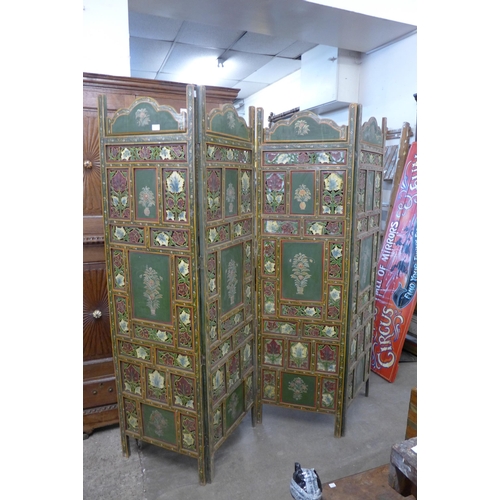 221 - An Eastern hand painted four panel folding dressing screen