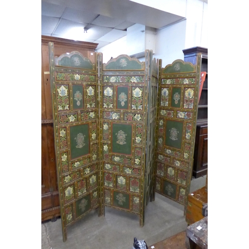 221 - An Eastern hand painted four panel folding dressing screen