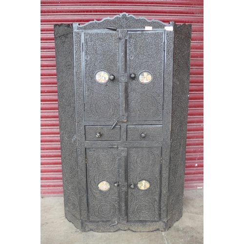 222a - An Indian heavily carved ebonised four door cupboard