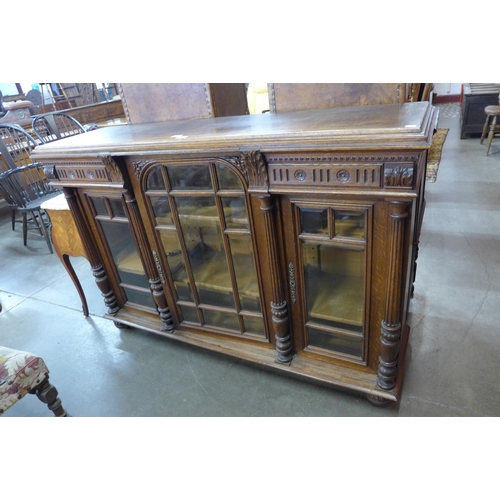 28 - A 19th Century French carved oak three door bookcase