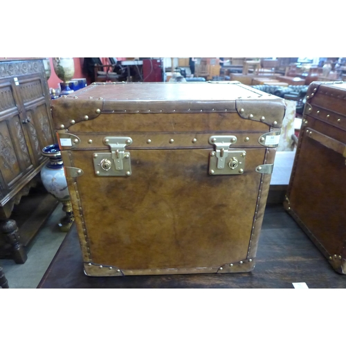 30 - A brown leather and brass mounted trunk