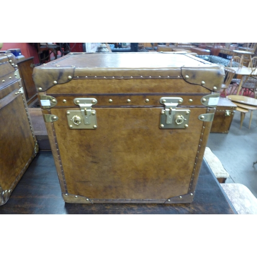 31 - A brown leather and brass mounted trunk