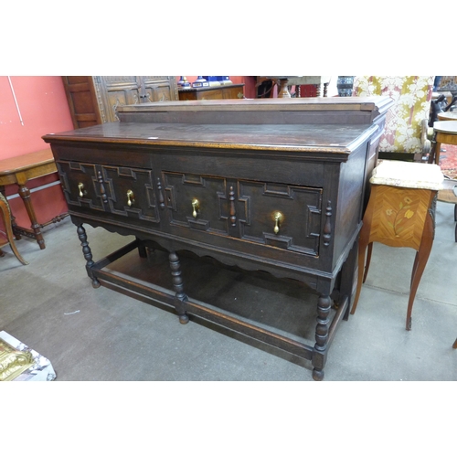 32 - An early 20th Century Jacobean Revival oak geometric moulded dresser