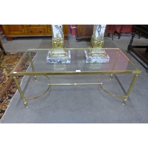 34 - An Italian brass and glass topped coffee table