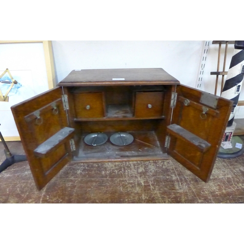 357 - A small Edward VII oak smokers cabinet