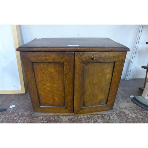 357 - A small Edward VII oak smokers cabinet