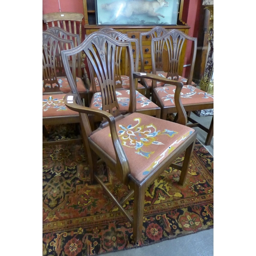 36 - An early 20th Century set of seven mahogany dining chairs in the Hepplewhite style with needlework d... 