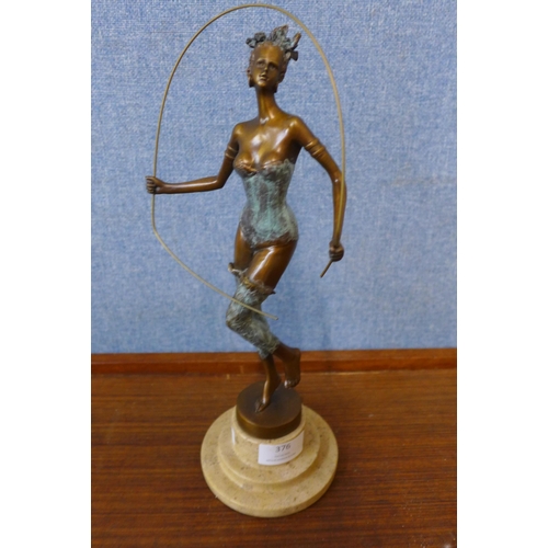 376 - An Art Deco style bronze figure of a female dancer, on cream marble socle