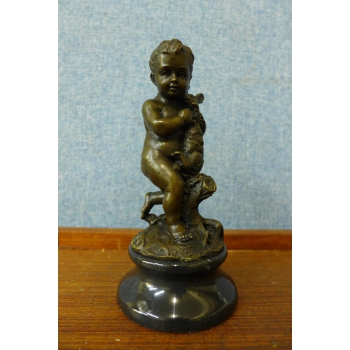 378 - A small French style bronze figure of a young boy and rabbit, on black marble socle