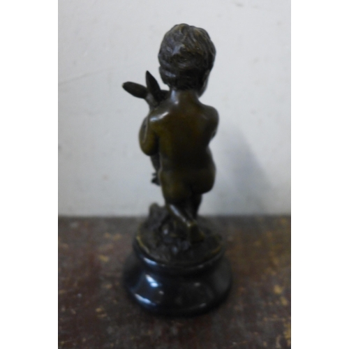 378 - A small French style bronze figure of a young boy and rabbit, on black marble socle