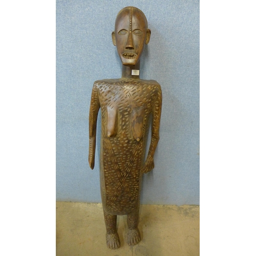 388 - An African carved wood figure of a woman