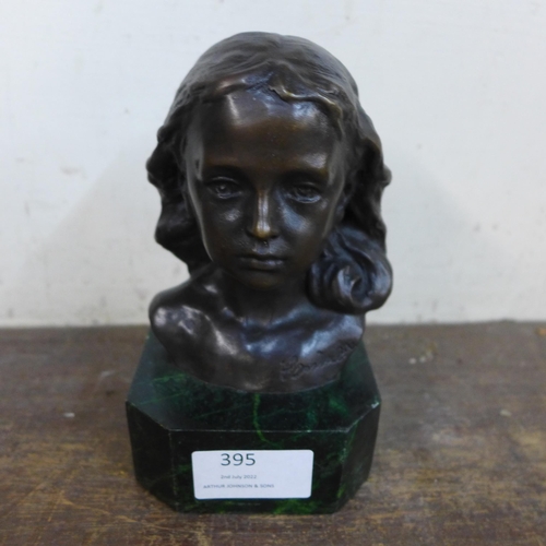 395 - A small bronze bust of a young girl