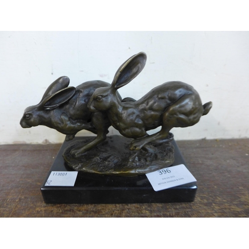 396 - A bronze figure of two running hares