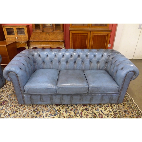 4 - A blue leather Chesterfield settee