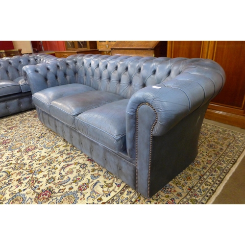 4 - A blue leather Chesterfield settee