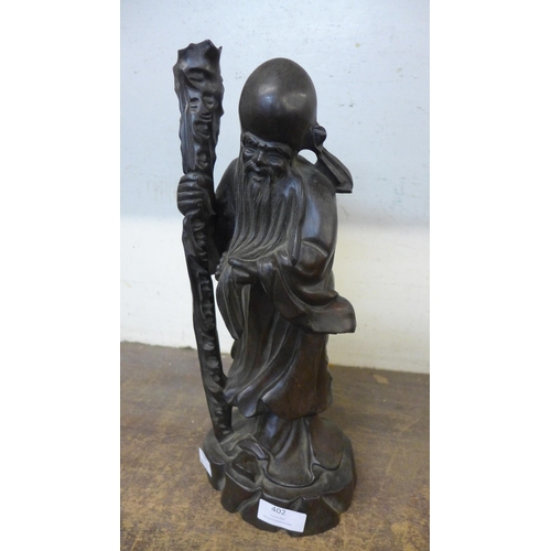 402 - A Chinese carved wooden figure of a sage