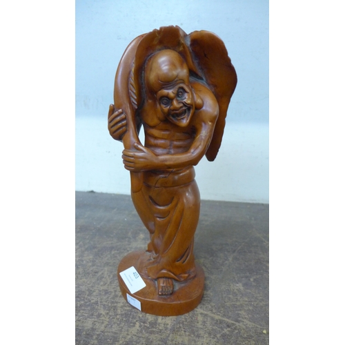 403 - A Chinese carved wooden figure of a mythical man