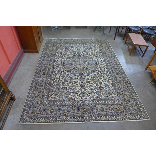 44 - A Persian cream ground Kashan rug, 350 x 250cms