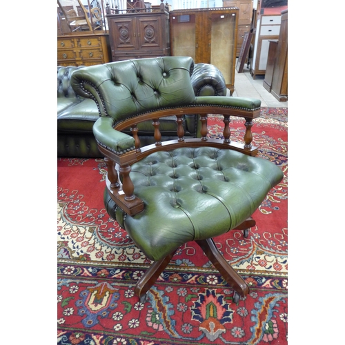 52 - A mahogany and green leather revolving Captain's desk chair