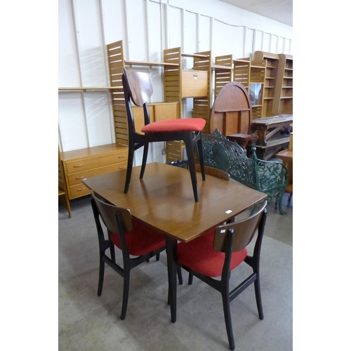 60 - A Nathan tola wood and black extending dining table and four chairs