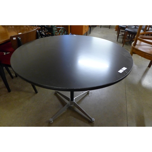 73 - An Eames style circular black and steel based kitchen table