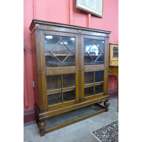 9 - An early 20th Century carved oak two door bookcase