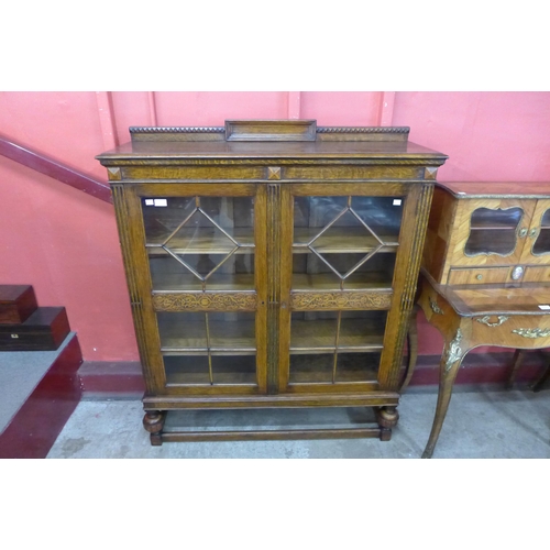 9 - An early 20th Century carved oak two door bookcase