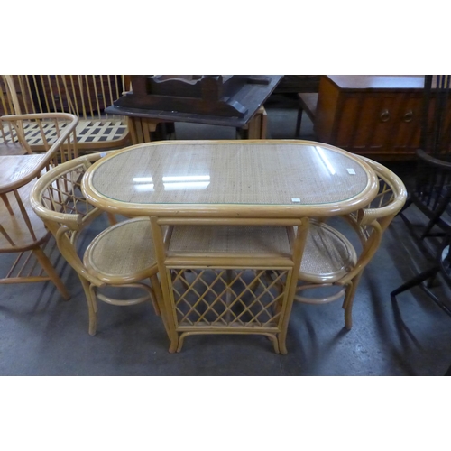 92 - A bamboo and glass topped table and two chairs