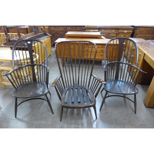 94 - A pair of Ercol dark elm and beech Windsor armchairs and an Ercol dark beech Evergreen armchair