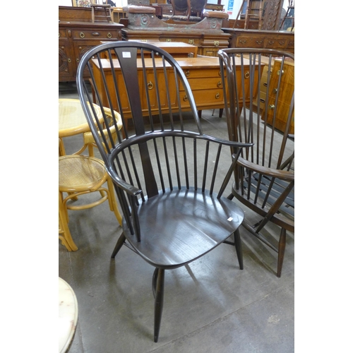 94 - A pair of Ercol dark elm and beech Windsor armchairs and an Ercol dark beech Evergreen armchair