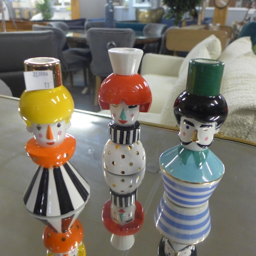 1430 - A set of three puppet people candlesticks