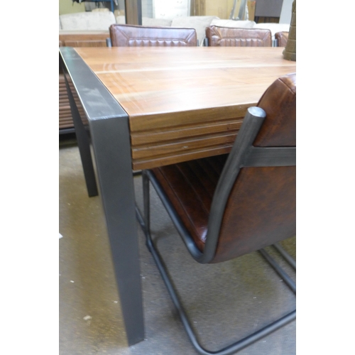 1536 - A Ribbed hardwood and gunmetal dining table with a set of six Novo chestnut chairs