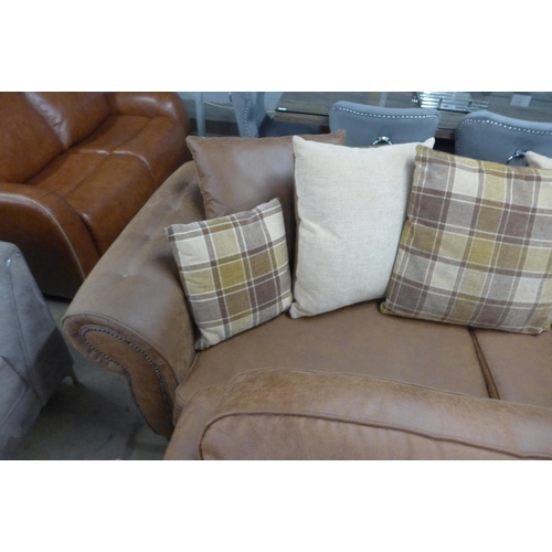 1557 - A County brown faux leather button back and studded four seater sofa and loveseat