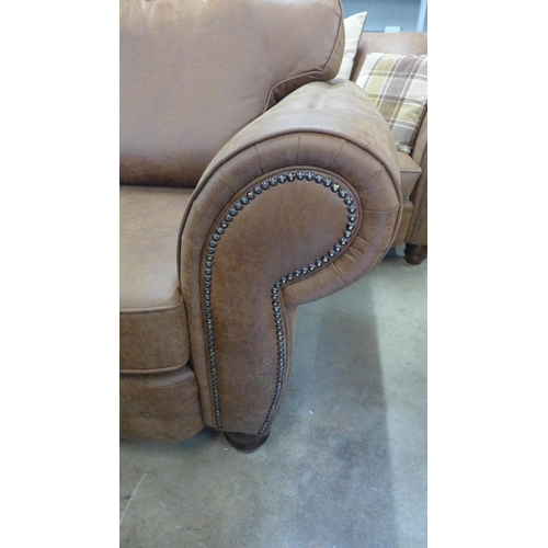 1557 - A County brown faux leather button back and studded four seater sofa and loveseat