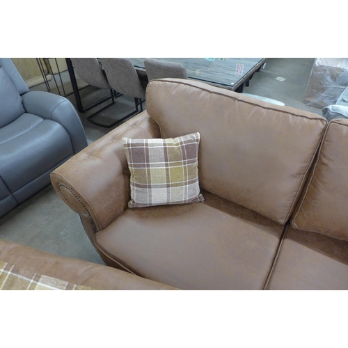 1558 - A County brown faux leather button back and studded three seater sofa and loveseat