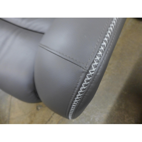 1575 - A slate leather and white stitching two seater and a pair of armchairs