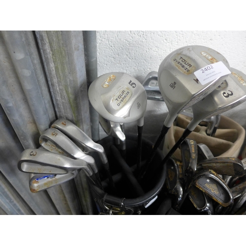 2402 - 5 golf bags with quantity of clubs including 10 Hippo, Lynx etc., bucket of balls and golf shoes