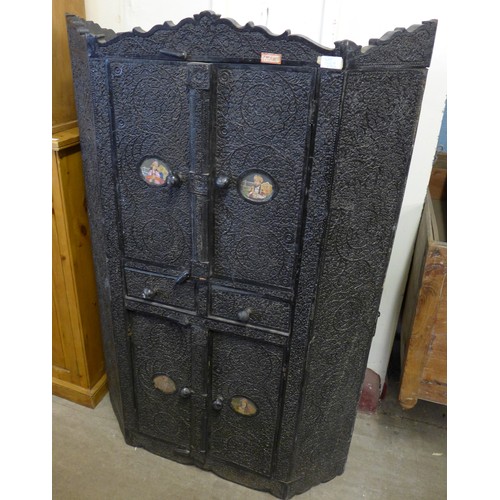 222a - An Indian heavily carved ebonised four door cupboard