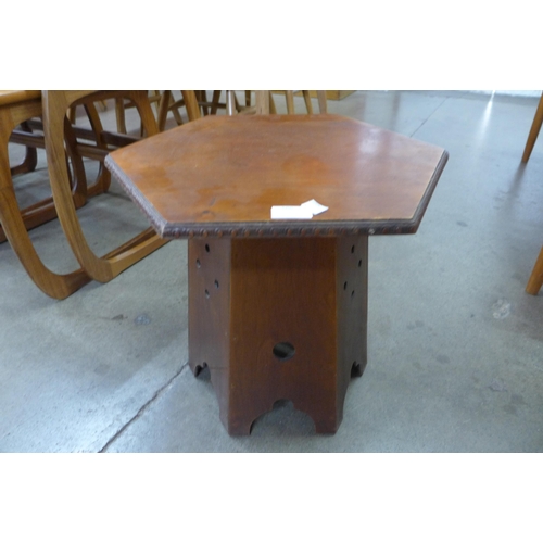 100 - An Arts and Crafts walnut hexagonal occasional table