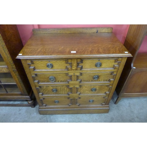 102 - An early 20th Century oak geometric moulded chest of drawers