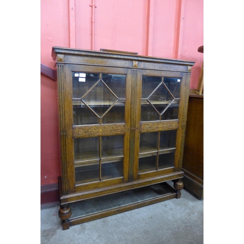 103 - An early 20th Century carved oak two door bookcase